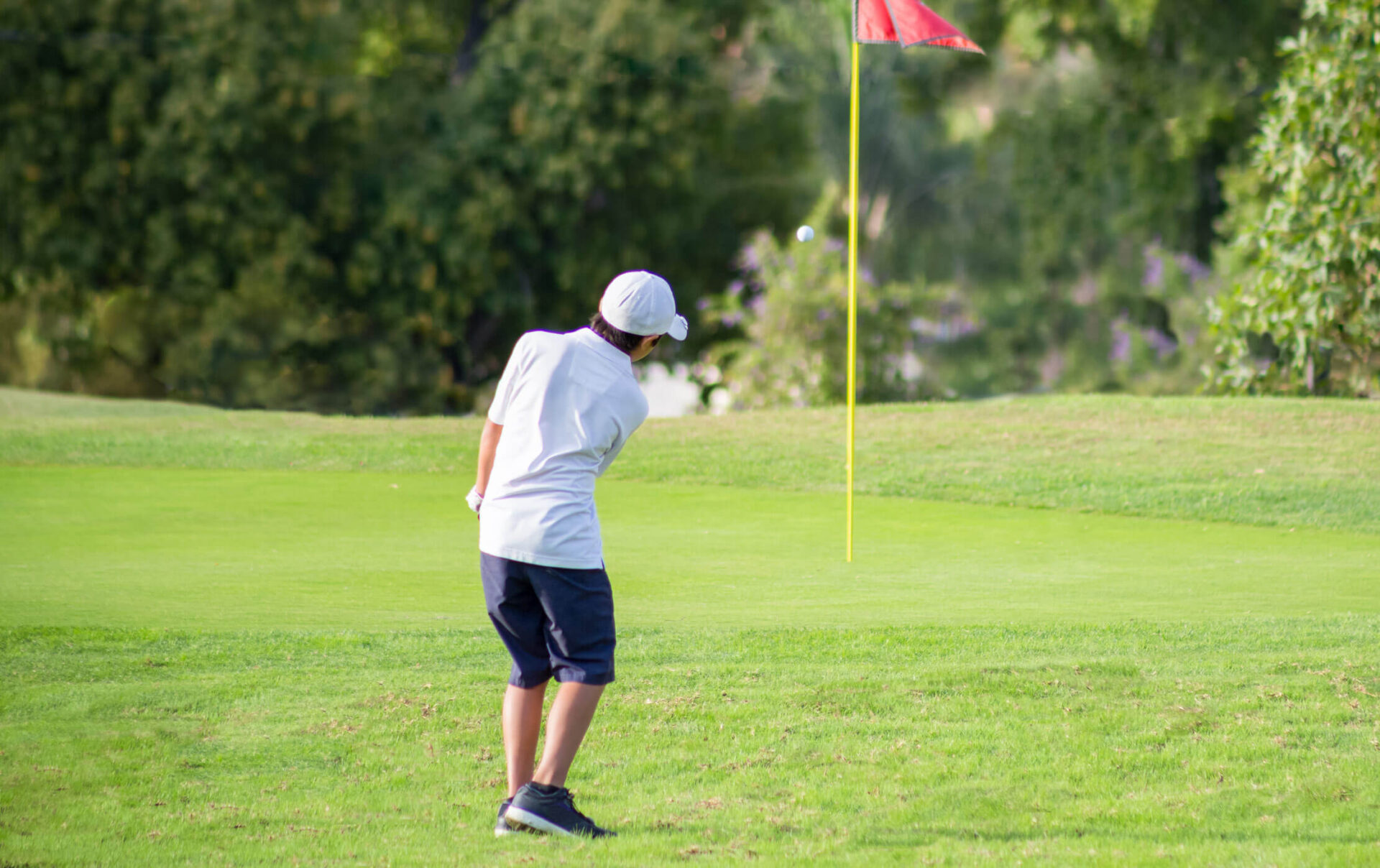 A kid playing golf